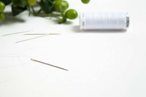 switzerland white thread on white surface needle